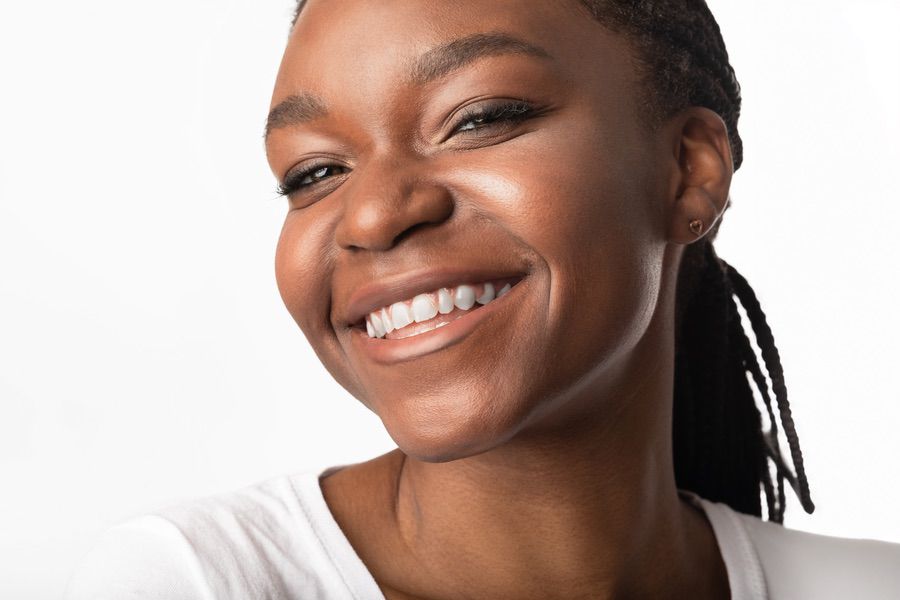 Portrait Of Black Girl In Dental Braces Smiling To Camera Posing On White Background. Orthodontics Concept. Studio Shot, Free Space